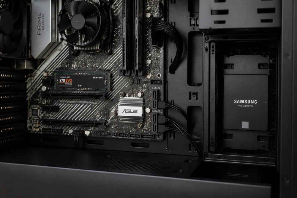 Wnętrze obudowy komputera z kartą graficzną ASUS, płytą główną i dyskiem SSD Samsung